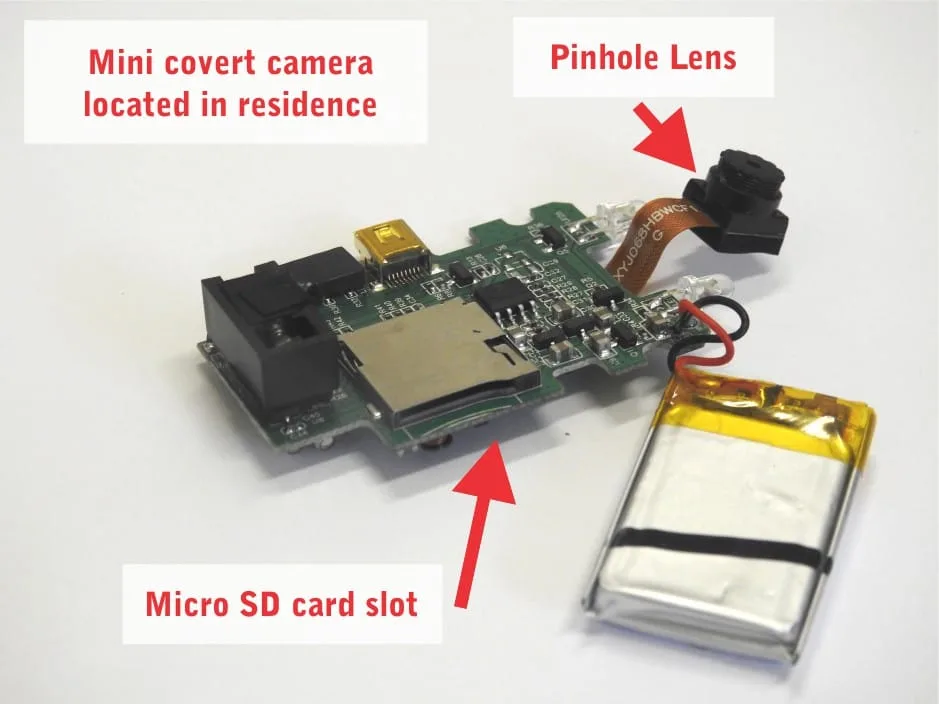 Miniature covert camera with pinhole lens and micro SD card slot located in a residence